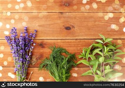 gardening, ethnoscience and herbs concept - bunches of lavender, dill and peppermint on wooden background. lavender, dill and peppermint on wooden background