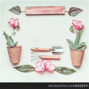Gardening frame with sign, tools, flowers and plant pots, shovel at light green background, top view, flat lay