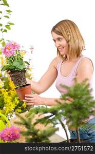 Gardening - Happy woman holding flower pot with blossoming flower on white background