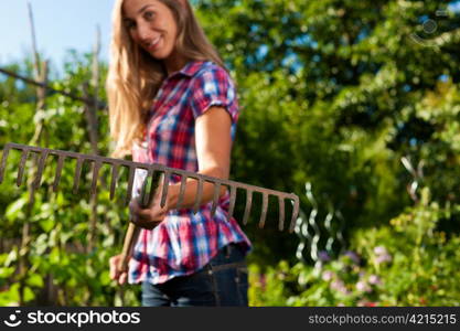 Gardening in summer - happy woman grate working