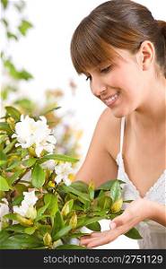 Gardening - Portrait of woman with Rhododendron flower on white background