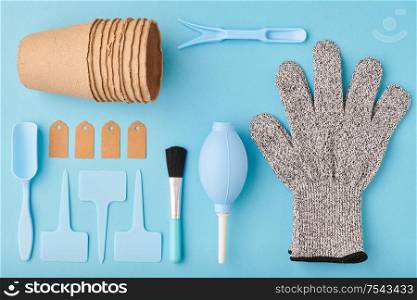 Gardening tools on blue background flat lay top view