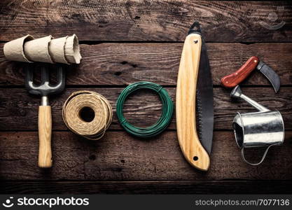 gardening tools on dark wooden background