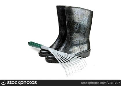Gardening tools: rubber boots and rake