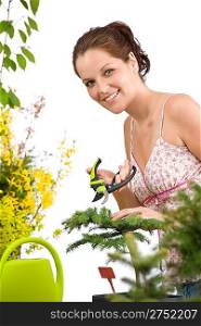 Gardening - woman cutting tree with pruning shears on white background