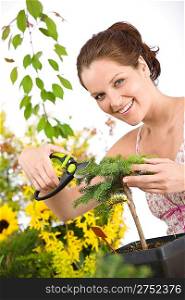Gardening - woman cutting tree with pruning shears on white background