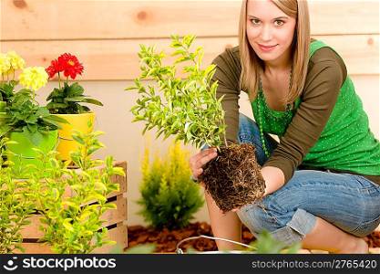 Gardening woman planting on terrace in spring