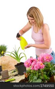 Gardening - woman sprinkling water to plant on white background
