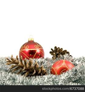garland with pine cones and baubles over a white background