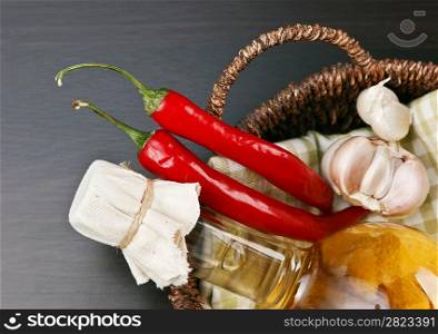 garlic and a basket with a bottle of vinegar