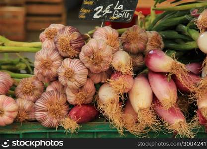 Garlic and onions at a market stall