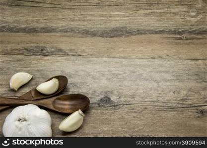 Garlic and wooden spoons. Rustic composition.