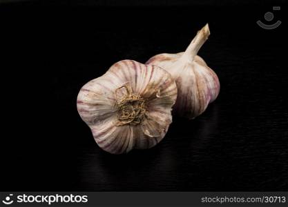 Garlic bulb closeup isolated on dark stone background
