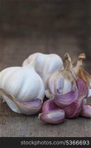 Garlic bulbs on grunge worn wooden background