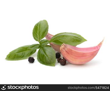 Garlic clove and basil leaf isolated on white background