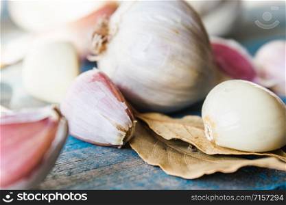 Garlic cloves and garlic bulbs on old blue boards. Healthy eating concept.. Garlic cloves and garlic bulbs on old blue boards.