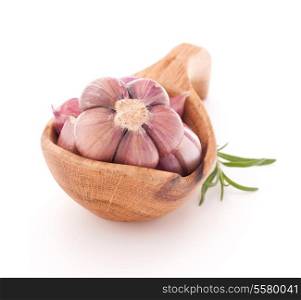 Garlic cloves in wooden bowl isolated on white background