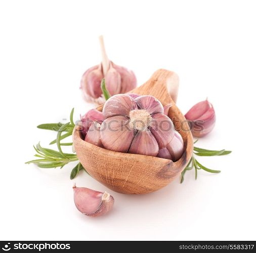 Garlic cloves in wooden bowl isolated on white background