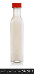 Garlic sauce in a glass bottle on white background with clipping path