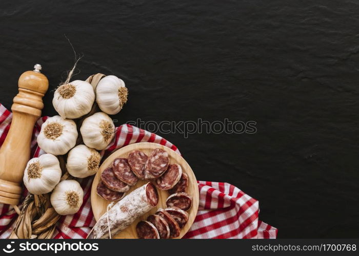 garlic sausages near spices napkin