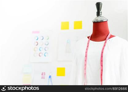 garment design on mannequin Red dummy with measuring tape in tailors fashion designer studio, Creative Design and Artistic Concept.