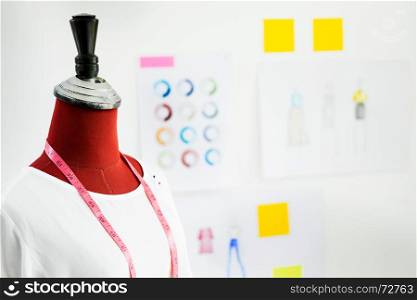 garment design on mannequin Red dummy with measuring tape in tailors fashion designer studio, Creative Design and Artistic Concept.
