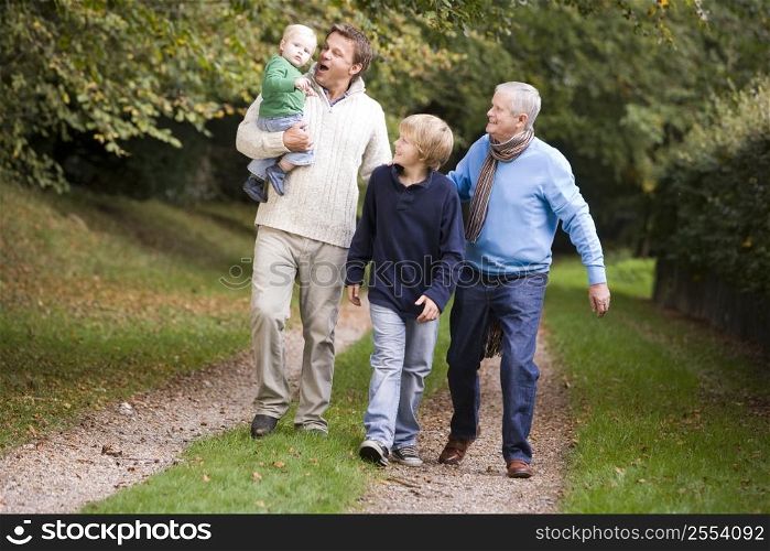 Garndfather Father and grandsons walking on path outdoors