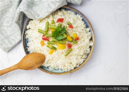 garnish rice with steamed vegetables risotto with wooden spoon for healthy eating