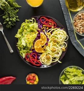 garnished healthy salad plate with dryfruits arranged black background