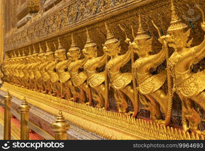 Garuda statue at Golden pagoda at Temple of the Emerald Buddha in Bangkok, Thailand. Wat Phra Kaew and Grand palace in old town, urban city. Buddhist temple, Thai architecture.