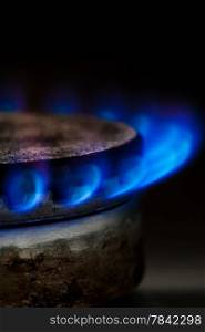 Gas burning by a dark blue flame on kitchen