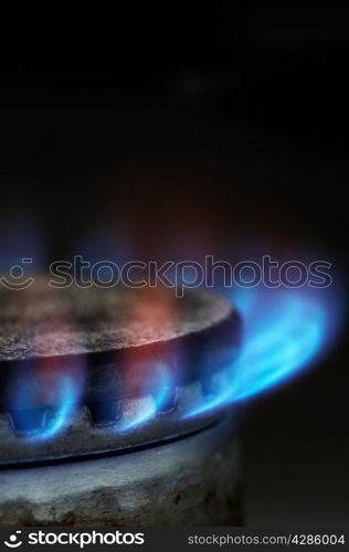 Gas burning by a dark blue flame on modern kitchen