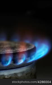 Gas burning by a dark blue flame on modern kitchen