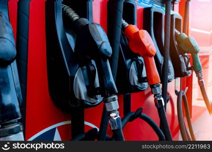 Gas pump nozzle in petrol station. Fuel nozzle in oil dispenser. Fuel dispenser machine. Refueling fill up with petrol gasoline and diesel. Petrol industry and service. Petroleum oil consumption.