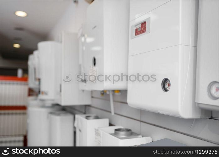 Gas water heating boilers choice on showcase in plumbering store. Sanitary engineering shop, nobody