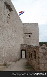 Gate of fortress and flag in Shibenik, Croatia