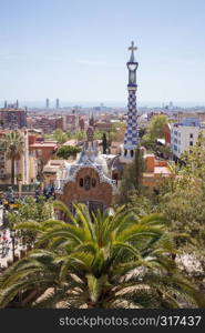 Gatehouse at the main entrance to Park Guell, which were originally designed as the caretaker's house. Barcelona, Spain.. Park Guell by architect Gaudi in a summer day, Barcelona, Spain.