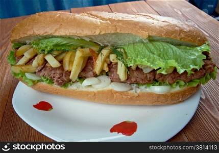 Gatsby - South African sandwich.Different varieties of Gatsbys include masala steak, chicken, polony, Vienna sausage, calamari, fish, and chargrilled steak.