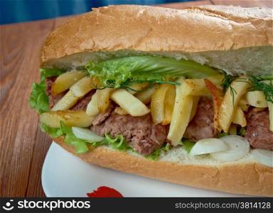 Gatsby - South African sandwich.Different varieties of Gatsbys include masala steak, chicken, polony, Vienna sausage, calamari, fish, and chargrilled steak.