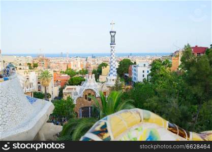 Gaudi spires and cityscape of Barcelona with the sea from park Guell, Spain. park Guell, Barcelona