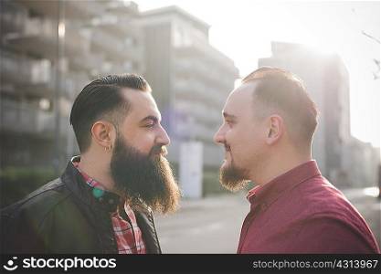 Gay couple face to face on street