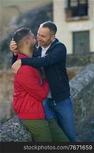 Gay couple in a romantic moment in a beautiful place near the river. Homosexual relationship concept.. Gay couple in a romantic moment outdoors