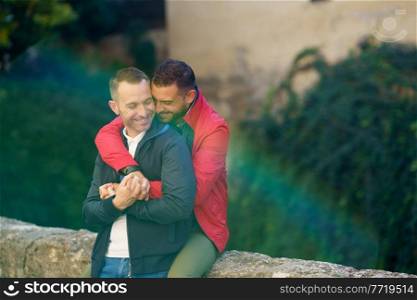 Gay couple in a romantic moment in a beautiful place near the river. LGTB relationship concept.. Gay couple in a romantic moment outdoors