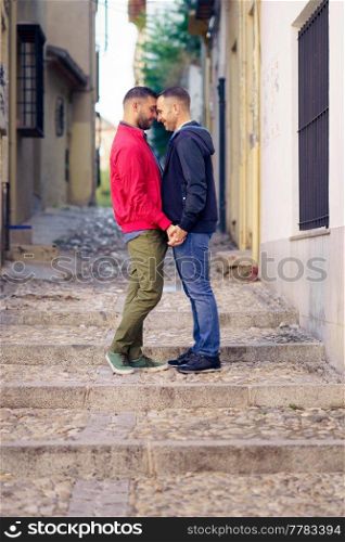 Gay couple in a romantic moment in the street. Lifestyle concept.. Gay couple in a romantic moment in the street.