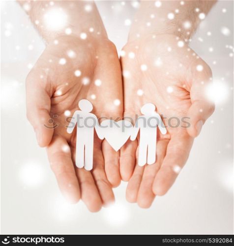 gay, lgbt, human rights concept - man hands showing two paper men with heart shape