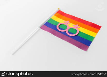 gay pride, homosexual and lgbt concept - female gender symbol on rainbow flag over white background. rainbow flag with venus symbol on white background. rainbow flag with venus symbol on white background