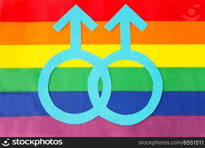 gay pride, homosexual and lgbt concept - male gender symbol on rainbow flag background. male gender mars symbol on rainbow flag background. male gender mars symbol on rainbow flag background