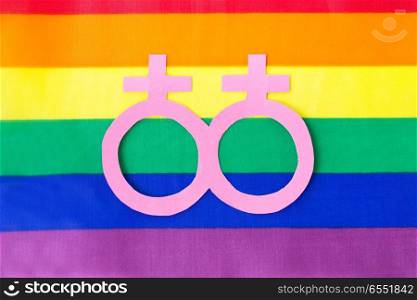 gay pride, homosexual and lgbt concept - venus or female gender symbol on rainbow flag background. venus or female symbol on rainbow flag background. venus or female symbol on rainbow flag background