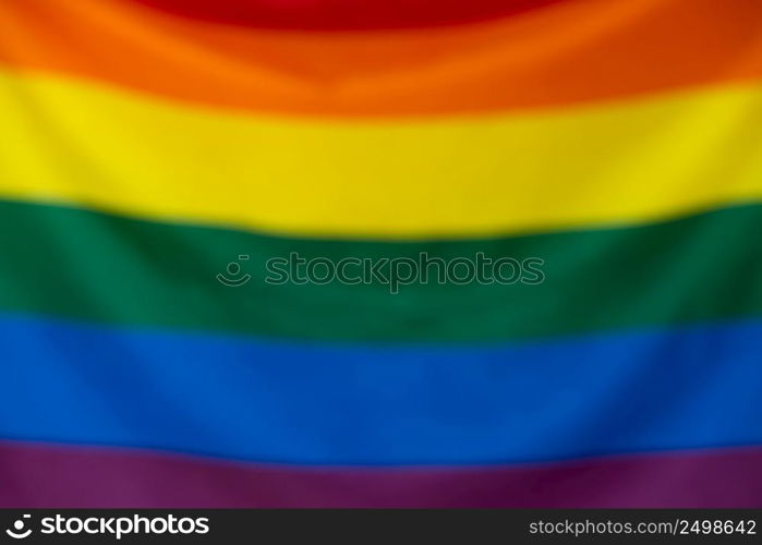 Gay pride LGBT flag blurred defocused bokeh background.