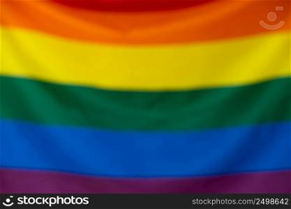 Gay pride LGBT flag blurred defocused bokeh background.